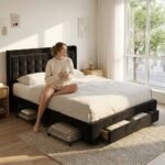 Lifestyle view of a woman relaxing on a custom black velvet tufted bed frame with storage. High-quality B2B custom bedroom furniture manufactured by MMK TRADE INC.