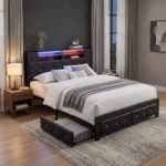 Modern black LED platform bed frame featuring a tufted faux leather headboard, built-in shelves, and under-bed storage drawers in a stylish bedroom setting. Manufactured by MMK Furniture Makers.