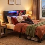 Woman relaxing on a modern black tufted bed with built-in LED headboard lighting. High-quality custom bedroom furniture manufactured by MMK TRADE INC for B2B wholesale.