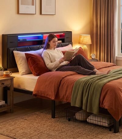 Woman relaxing on a modern black tufted bed with built-in LED headboard lighting. High-quality custom bedroom furniture manufactured by MMK TRADE INC for B2B wholesale.