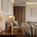brass cylindrical base crackle glass table lamp on wooden nightstand in luxury hotel bedroom suite