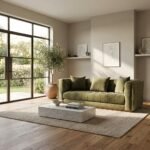 Custom-made olive green tufted velvet sofa with solid wood base by MMK Furniture Makers in a sunlit modern living room setting.