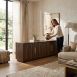 Modern dark walnut TV stand FNLRTV-6014 with brass hardware styled by a woman in a bright contemporary living room by MMK Furniture Makers