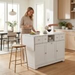 Woman using a white multifunctional kitchen island cabinet with storage drawers and drop-leaf table in an open-concept kitchen