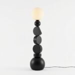 A-full-view-clean-architectural-studio-shot-of-the-stacked-geometric-floor-lamp-showing-its-unique-black-shapes-and-spherical-shade-in-a-light-filled-minimalist-room.