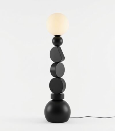 A-full-view-clean-architectural-studio-shot-of-the-stacked-geometric-floor-lamp-showing-its-unique-black-shapes-and-spherical-shade-in-a-light-filled-minimalist-room.
