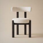 A-single-modern-dining-chair-with-a-dark-ash-wood-frame-and-off-white-chenille-upholstery-shown-frontal-against-a-neutral-background.