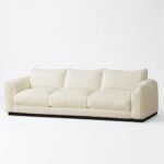 1.Front-view-of-a-luxurious-modern-cream-3-seater-sofa-with-a-dark-wood-base-isolated-on-a-clean-white-background-manufactured-by-MMK-Furniture-Makers.