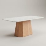 Modern-dining-table-with-Calacatta-white-stone-top-and-faceted-oak-pedestal-base-by-MMK-Furniture-Makers.