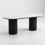 Modern-dining-table-with-a-capsule-white-marble-top-and-two-black-fluted-cylindrical-legs.