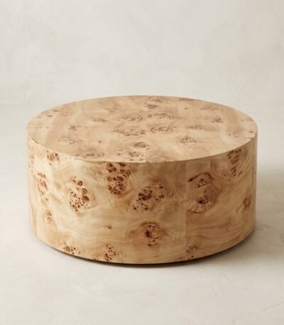 Modern-round-burl-wood-coffee-table-with-natural-swirling-grain-on-an-off-white-studio-background.