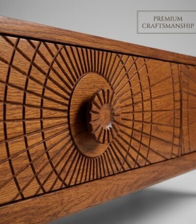 Close-up-of-the-sunburst-carved-drawer-front-on-the-oak-table