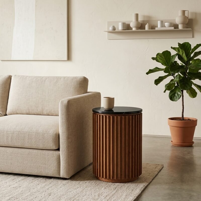 Custom-round-fluted-wood-accent-table-placed-next-to-a-modern-sofa.