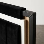 Detailed-corner-view-of-a-high-end-bedstead-showing-velvet-white-trim-and-metal.