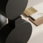 Macro-view-focusing-on-the-joinery-between-the-geometric-shapes-of-the-floor-lamp-highlighting-the-matte-black-iron-finish-and-the-precise-connection-points.