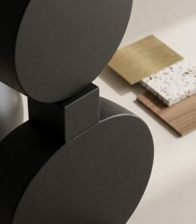 Macro-view-focusing-on-the-joinery-between-the-geometric-shapes-of-the-floor-lamp-highlighting-the-matte-black-iron-finish-and-the-precise-connection-points.
