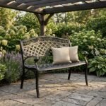 The-cast-aluminum-patio-bench-in-a-landscaped-garden-patio-setting.