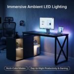 Modern-black-desk-illuminated-with-ambient-smart-LED-light-strip-in-dark-room.