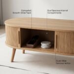 Oval-wood-coffee-table-with-sliding-tambour-door-opened-revealing-spacious-interior-storage.