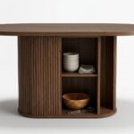 Pedestal-base-of-dining-table-showing-open-storage-shelves-and-sliding-fluted-door.