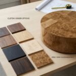 A-Burl-wood-coffee-table-alongside-various-wood-veneer-samples-for-custom-finish-selection.