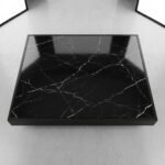 .High-angle-top-down-view-of-rectangular-black-faux-marble-tabletop-with-realistic-white-veining-patterns.