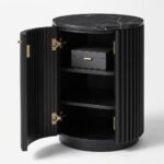 Interior-storage-space-of-round-fluted-wood-side-table-with-opened-door.