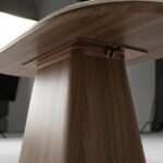 Low-angle-detail-of-the-walnut-pedestal-base-and-structural-joint.