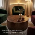 Styled-poplar-burl-coffee-table-with-ceramic-vase-and-art-books-in-an-upscale-lounge.