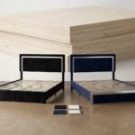 Side-by-side-comparison-of-black-and-navy-blue-velvet-upholstered-bedsteads.