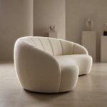 5.Side-profile-of-sculptural-curved-sofa-highlighting-ergonomic-kidney-shape-and-fluted-back