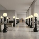 A-visualization-of-dozens-of-the-geometric-floor-lamps-curated-within-an-expansive-modern-office-lounge-and-hotel-reception-area-reinforcing-the-contract-ready-capability-for-large-projects.