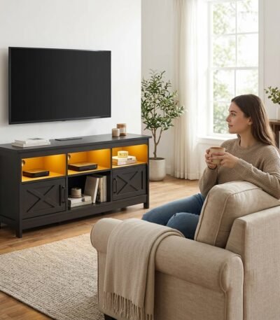 Woman relaxing in living room featuring a custom wholesale black TV console with built-in power outlets