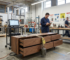 Factory quality control testing showing a heavy weight applied to the open drawers of a commercial TV stand to verify ASTM F2057 anti-tip compliance.